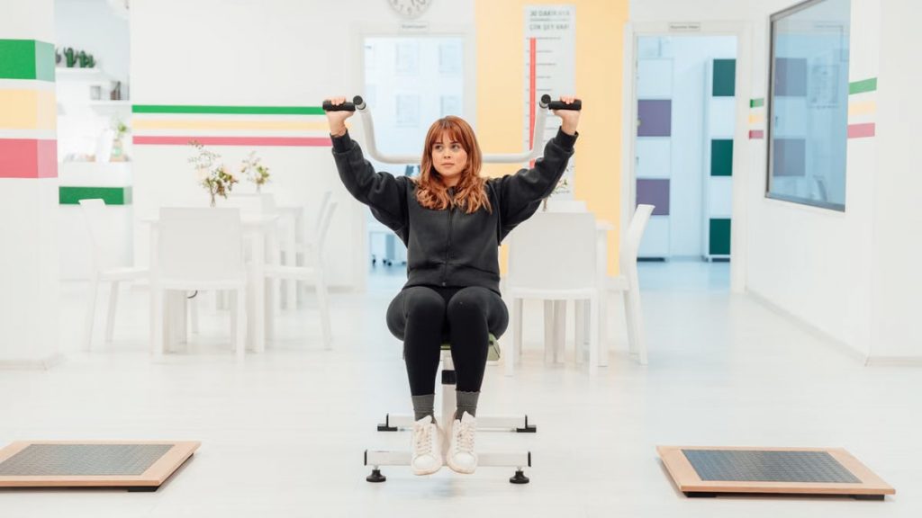 A woman exercising with weights indoors at a fitness facility in Yalova, Türkiye.